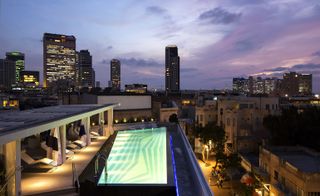 Rooftop pool with undercover loungers