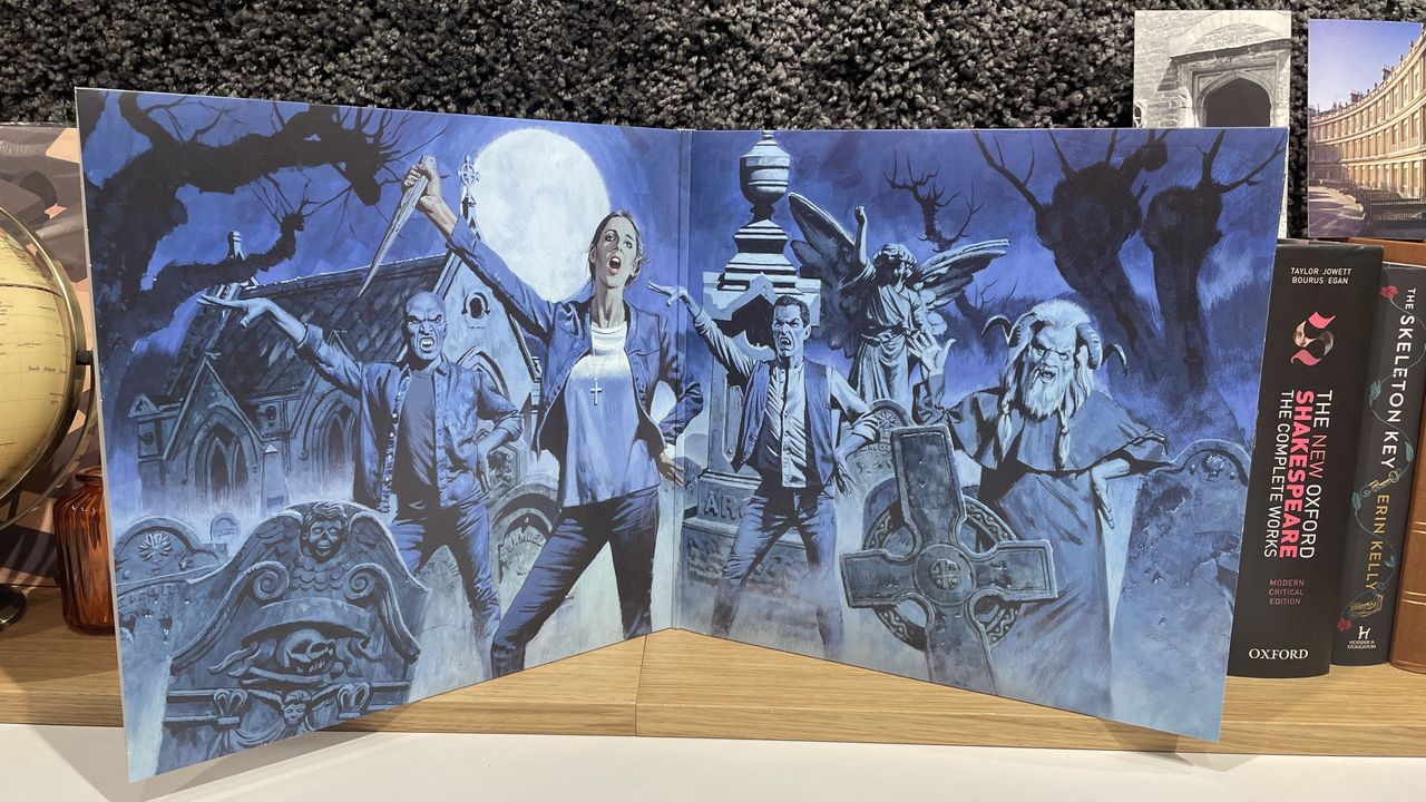 The inside cover of Once More With Feeling showing an illustration of Buffy and other characters in a graveyard at night.