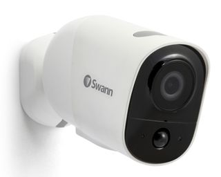 a white security camera branded with Swann on the side