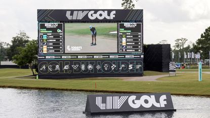 A LIV Golf screen and sign on a lake at the LIV Golf Houston tournament in 2024