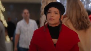 Christina Milian look annoyed in a red coat over a black top with a black beret in Meet Me Next Christmas