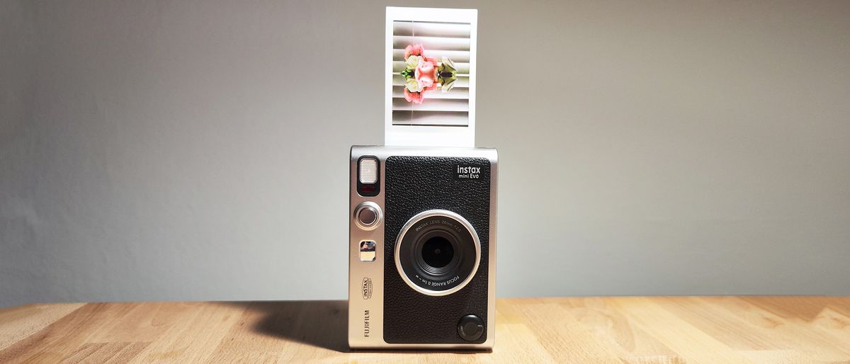 The Fujifilm Instax Mini Evo on a wooden table