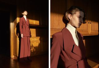 Model wears chestnut colour suit with high collar cream blouse underneath