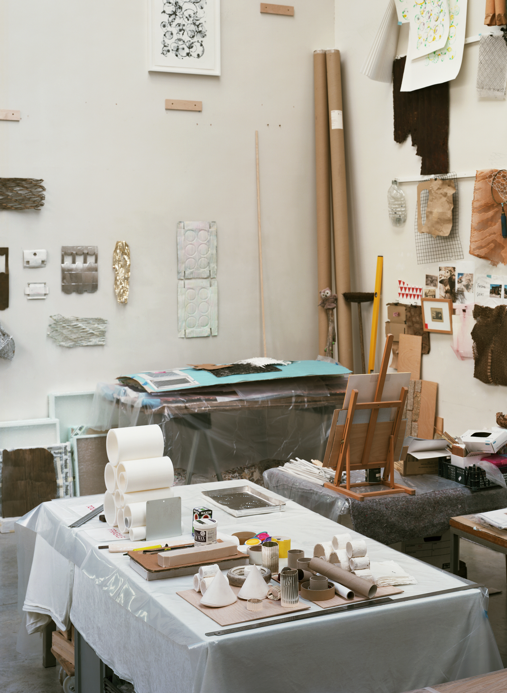 Silver objects with a ridged surface, shown in the context of a messy artist&#039;s studio