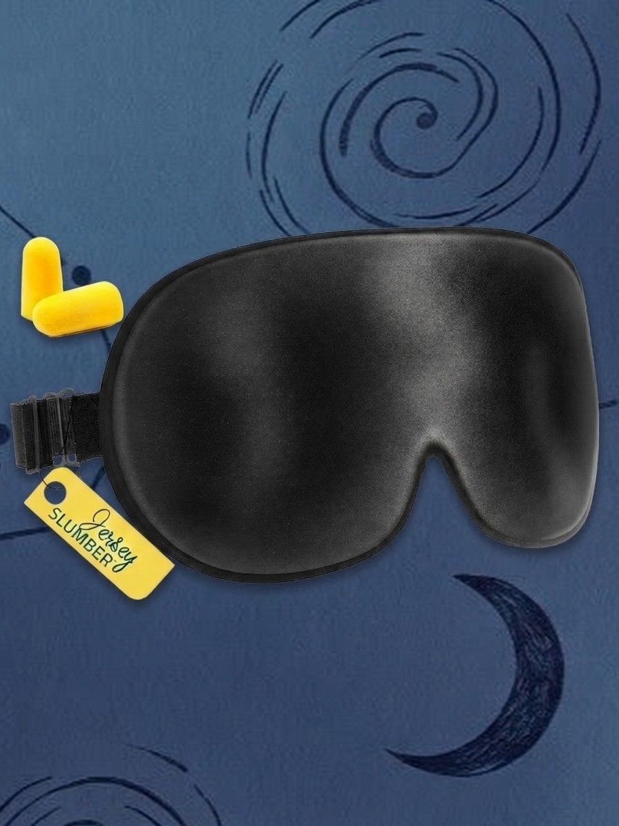 A black Jersey Silk Sleep Mask and yellow ear plugs against a blue background of stars, edited by Gemini