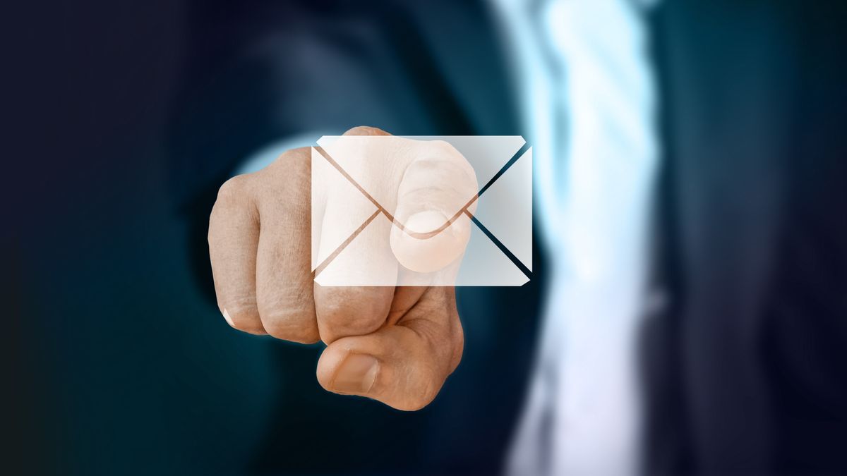 Close up of a person touching an email icon.