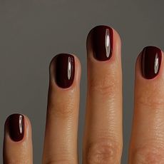 A close up of dark burgundy nails