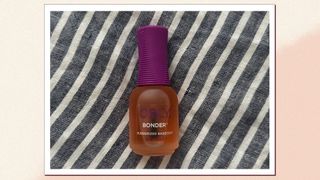 A bottle of ORLY Bonder base coat on a blue stripe background