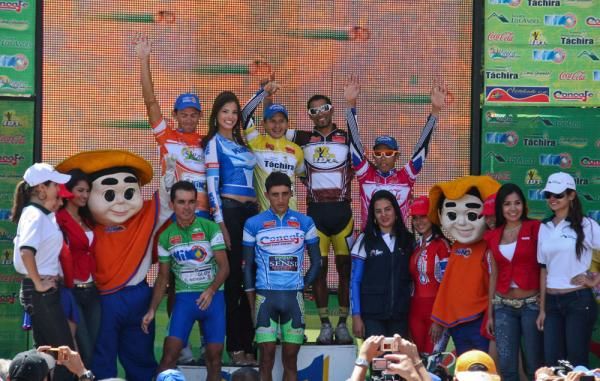 The jersey wearers celebrate on the podium