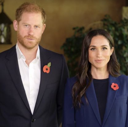 Prince harry and Meghan Markle wearing blue blazers and red poppy pins