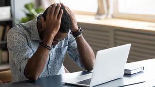 Frustrated man with laptop