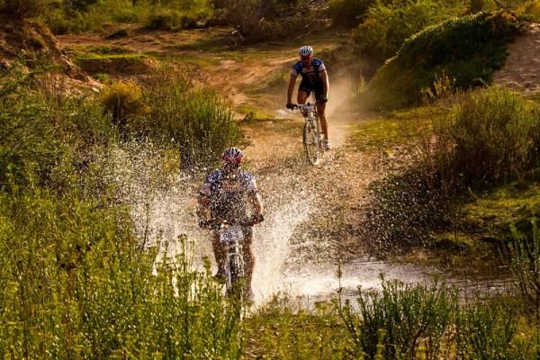 Two racers cross a stream.
