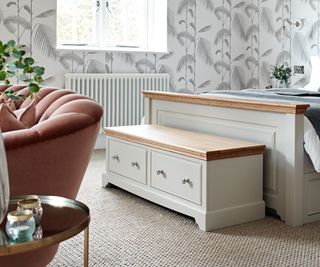 wooden and painted chest at end of bed