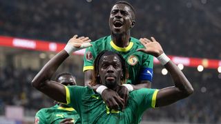 Cherif Ndiaye (hands raised) celebrates scoring Senegal's third goal with Idrissa Gueye during the Africa Cup Of Nations Group D match between Benin and Senegal at the Grand Stade de Tanger on December 30, 2025 in Tangier, Morocco.