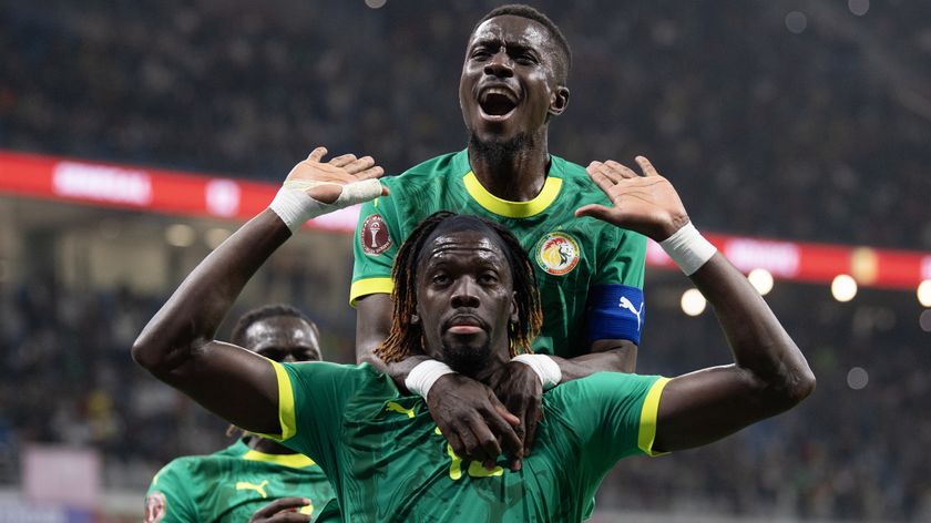Cherif Ndiaye (hands raised) celebrates scoring Senegal's third goal with Idrissa Gueye during the Africa Cup Of Nations Group D match between Benin and Senegal at the Grand Stade de Tanger on December 30, 2025 in Tangier, Morocco. 