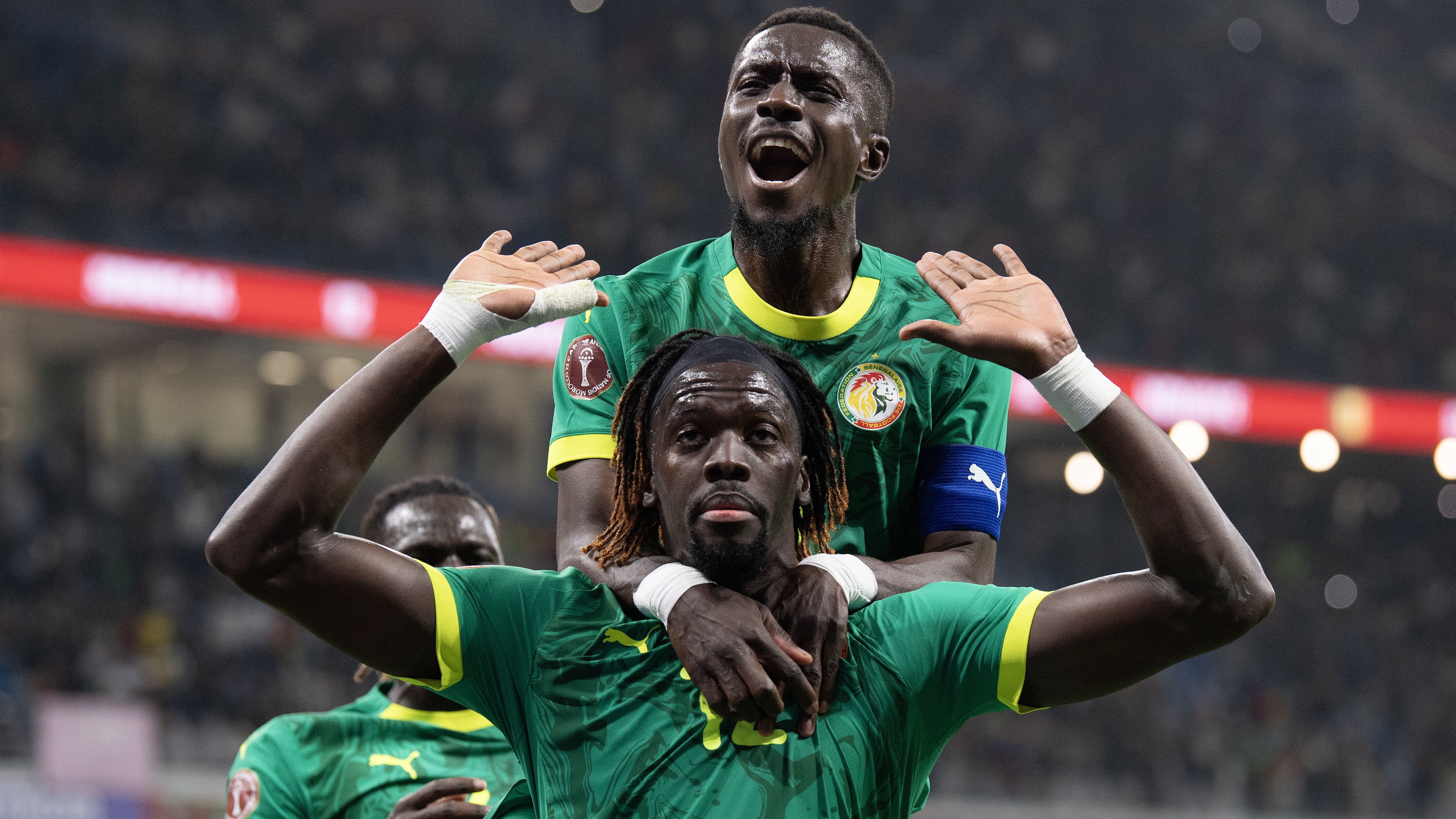 Cherif Ndiaye (hands raised) celebrates scoring Senegal's third goal with Idrissa Gueye during the Africa Cup Of Nations Group D match between Benin and Senegal at the Grand Stade de Tanger on December 30, 2025 in Tangier, Morocco. 