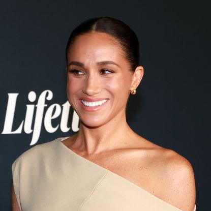 Meghan Markle wears a nude off the shoulder gown