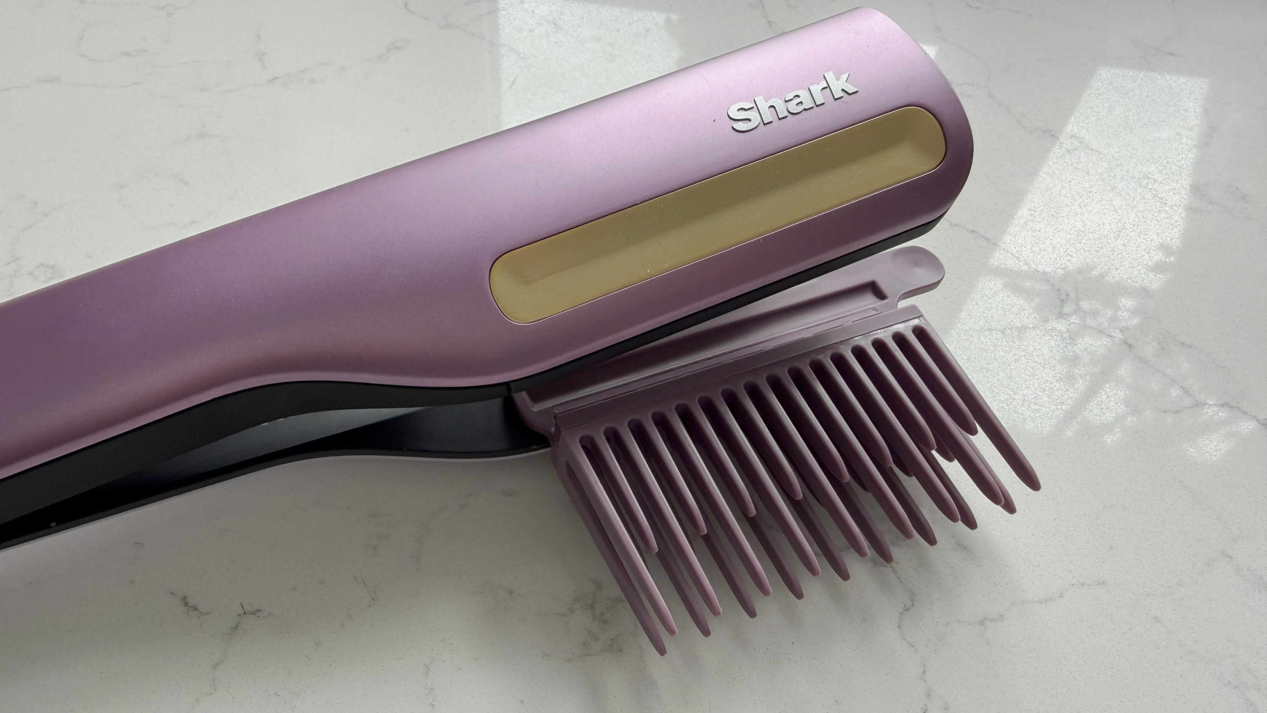 Close-up of the Shark SilkiPro Straight with the wide-tooth comb attachment clipped in, showing the gold cool-touch strip and Shark logo