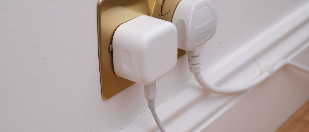 Apple 20W wall charger in a plug socket