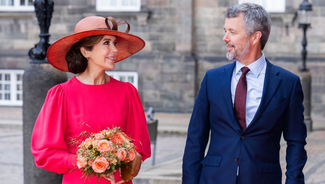 Queen Mary of Denmark wears a hot pink dress with puff sleeves at a royal danish ceremony