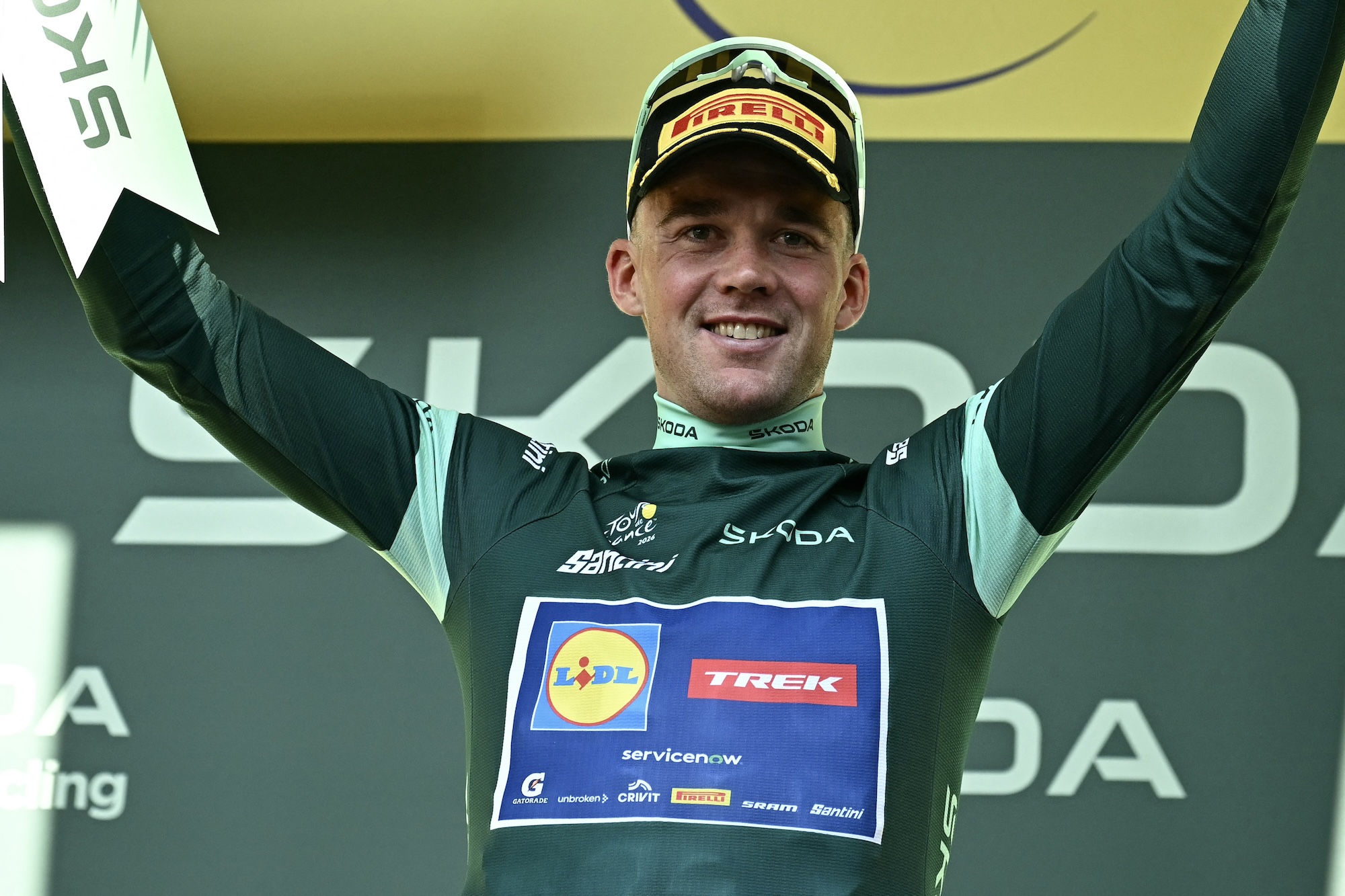 Mads Pedersen (Lidl-Trek) celebrates on the podium after stage 17 with the best sprinter's green jersey, though his margin was reduced by stage winner Jasper Philipsen
