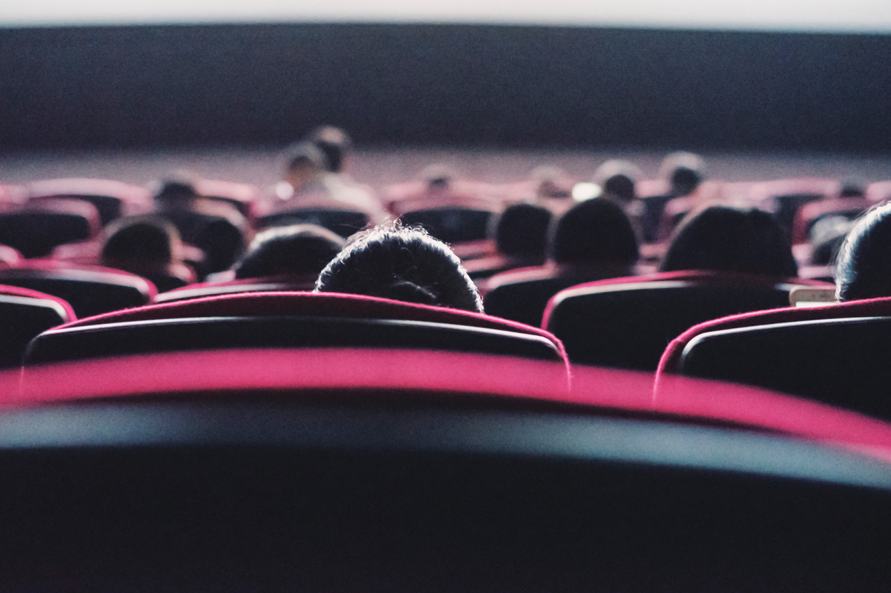 people in seast watchign the big screen at the cinema