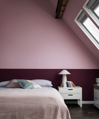 Two-tone bedroom with deep red lower wall and contrast lighter pink upper wall and ceiling