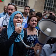 A woman speaks in megaphone at a London march, calling for a ceasefire between Israel and Palestine