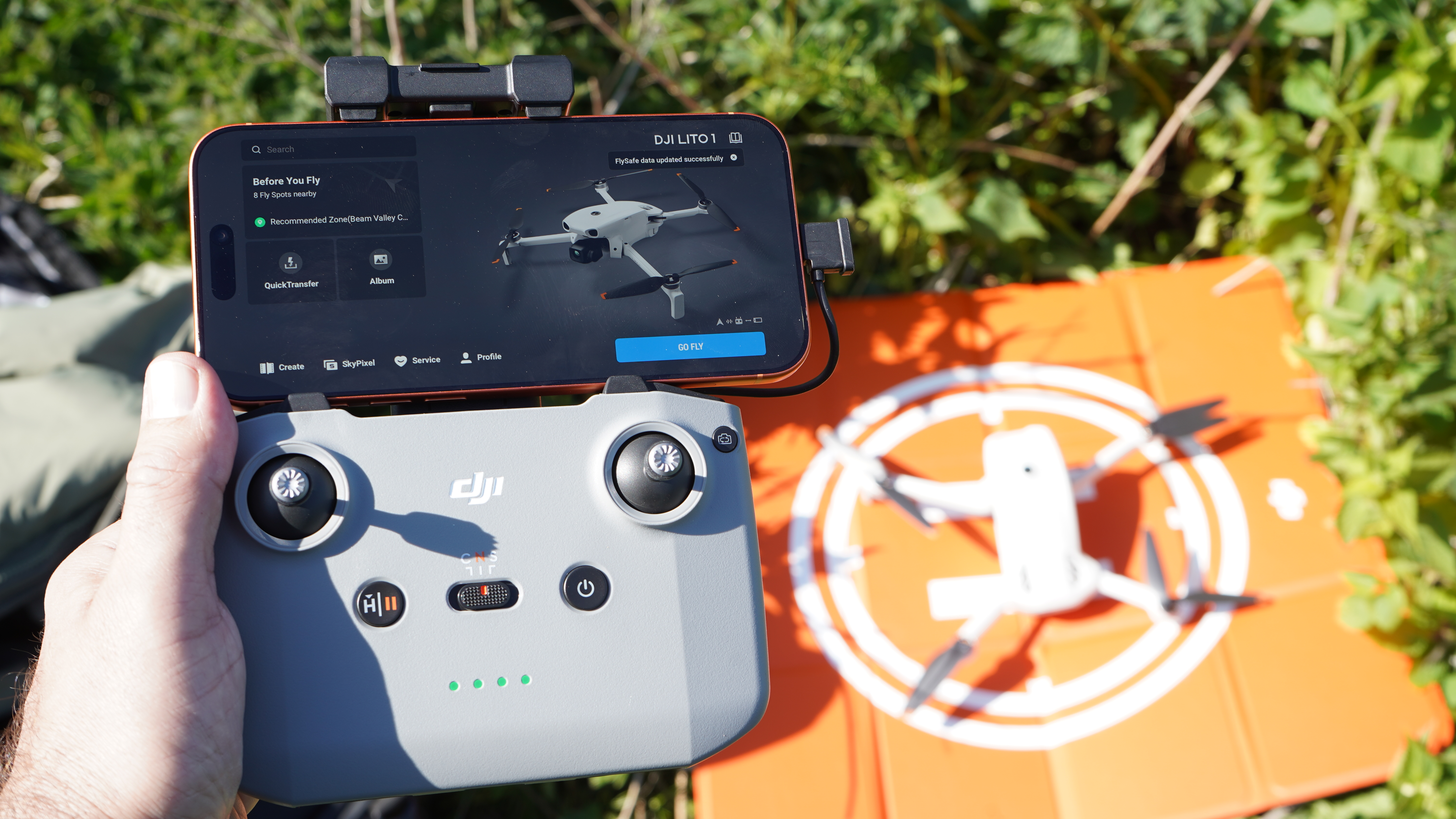 DJI Lito 1 and DJI RC 3 remote controller in hand with iPhone 17 Pro Max