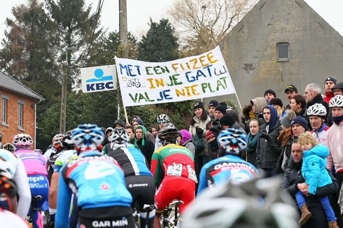 Racers pass by fans who came out despite the cold