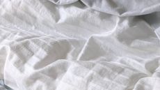Close up of a white duvet cover, sleep tips