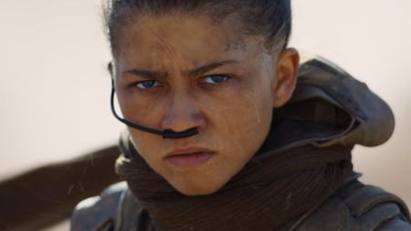 Zendaya covered in sand wearing a nosepiece