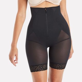 A close up of a woman wearing slightly seethrough shapewear long shorts