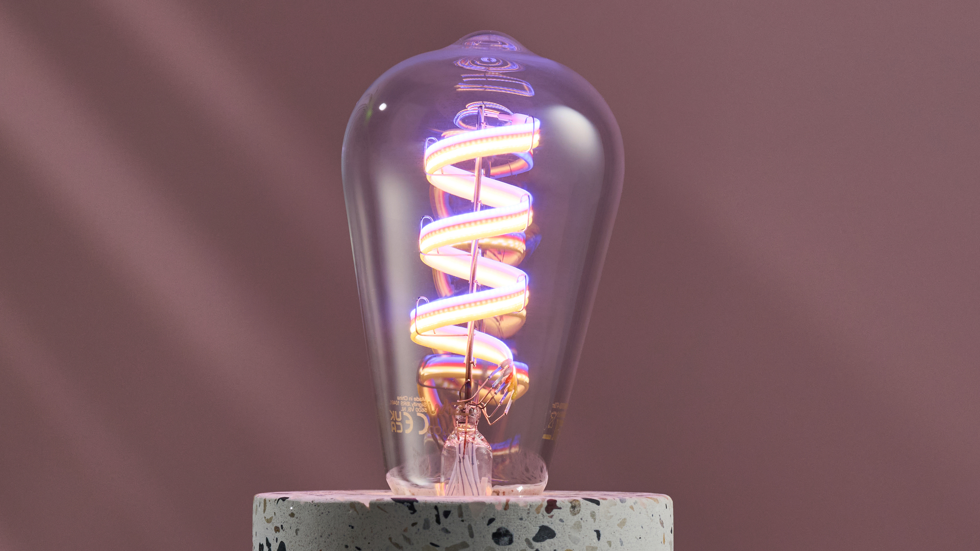 The LEDs are clearly visible on the strip inside the WiZ filament bulb.
