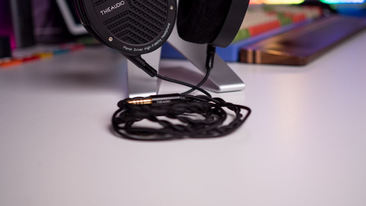 Close view of the Thieaudio Wraith's balanced 4.4mm cable on a white table