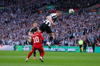 LONDON, ENGLAND - MARCH 16: Dan Burn of Newcastle United scores their side's first goal during the Carabao Cup Final between Liverpool and Newcastle United at Wembley Stadium on March 16, 2025 in London, England. (Photo by James Gill - Danehouse/Getty Images)