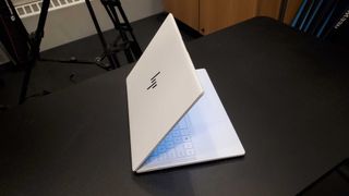 a white laptop opened and facing away