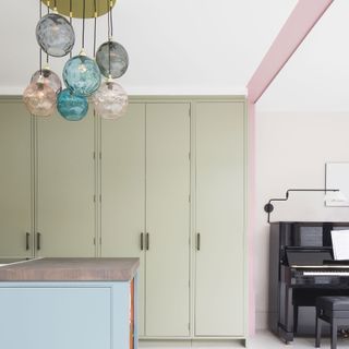 Kitchen with green pastel cupboards