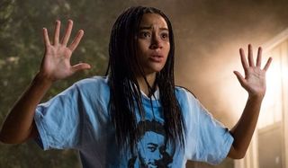 Amandla Stenberg holding her hands up in The Hate U Give