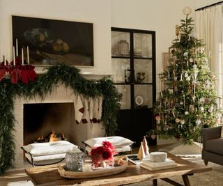 traditional christmas decorations in a neutral living room decorated with a large garland