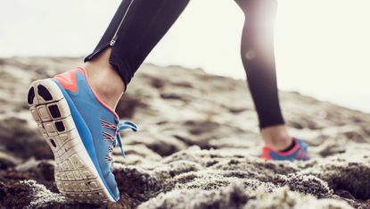 woman sneakers woman running on dirt path