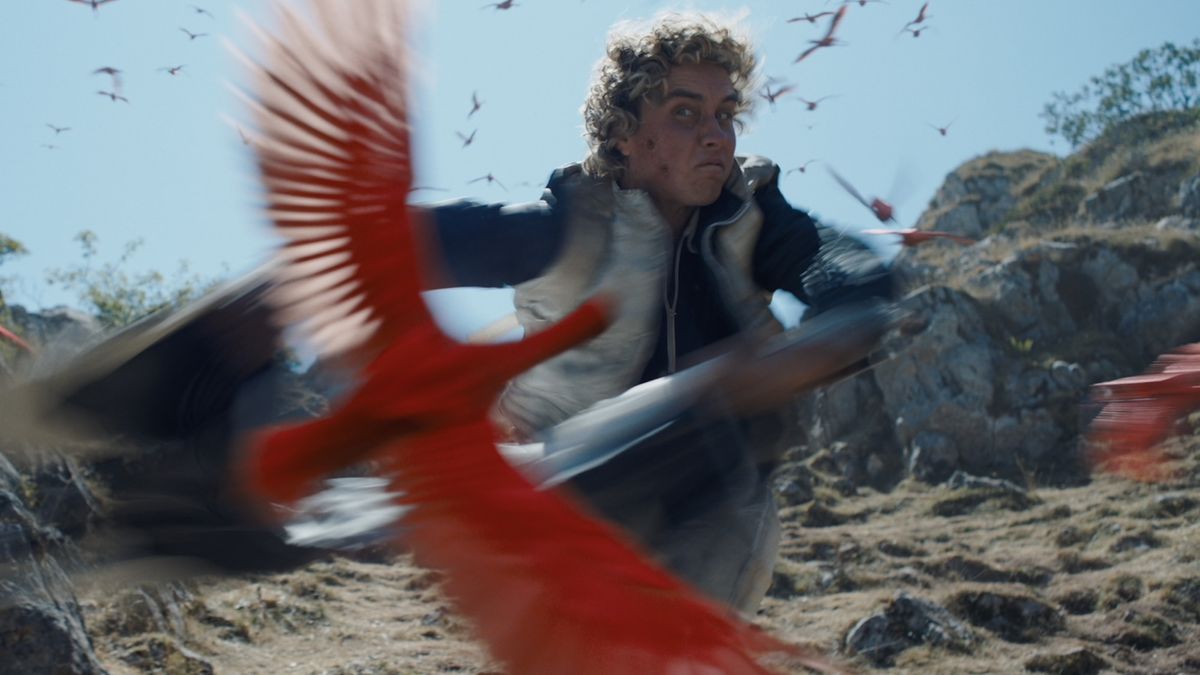 Haymitch being attacked by a red bird in The Hunger Games: Sunrise on the Reaping