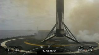 The first stage of a SpaceX Falcon 9 rocket rests on one of the company's drone ships shortly after landing on March 17, 2023.