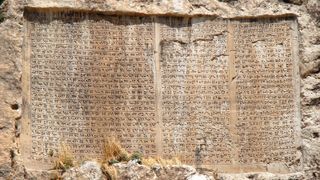 cuneiform markings on a clay surface