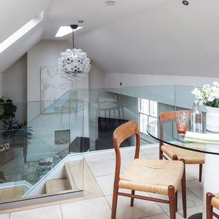 mezzanine with dining table and chairs and stair