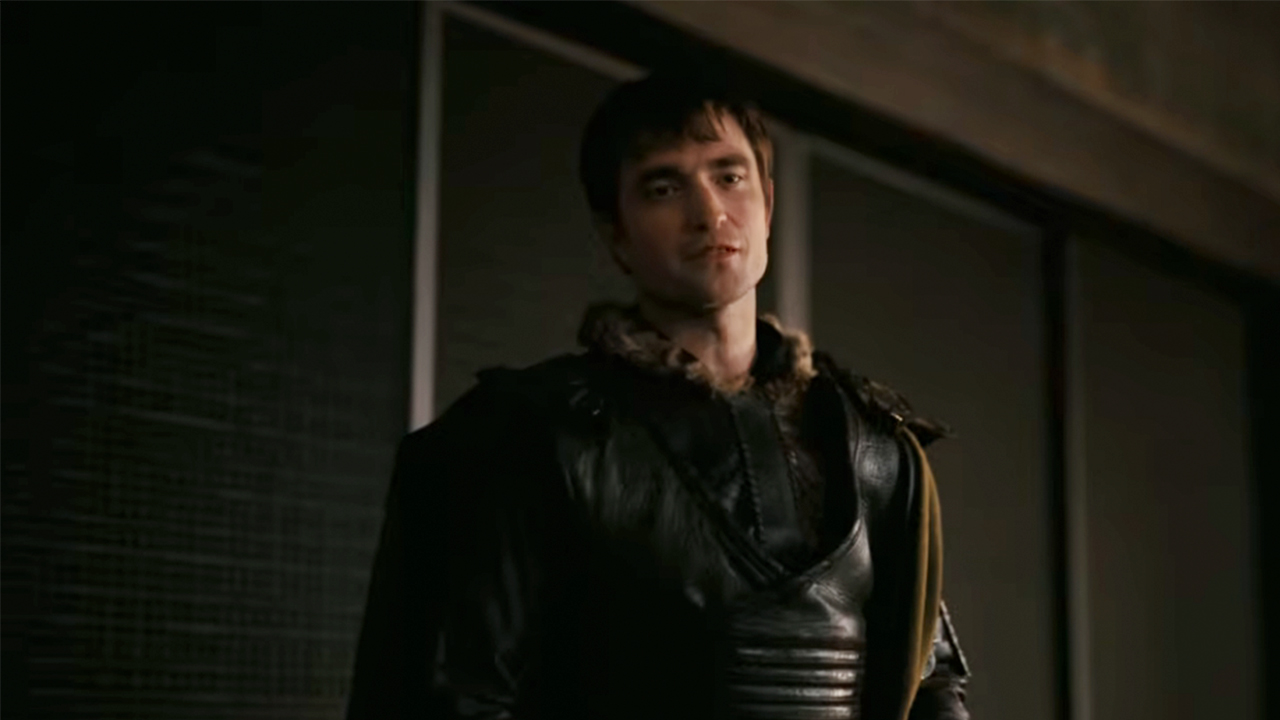 Robert Pattinson in black armor, looking angry in The Odyssey