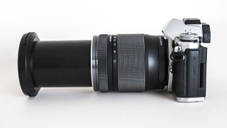 While it collapses down small, the 12-200mm can feel imbalanced on smaller bodies without a battery grip