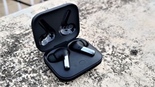 The OnePlus Buds Pro earbuds in black in their charging case