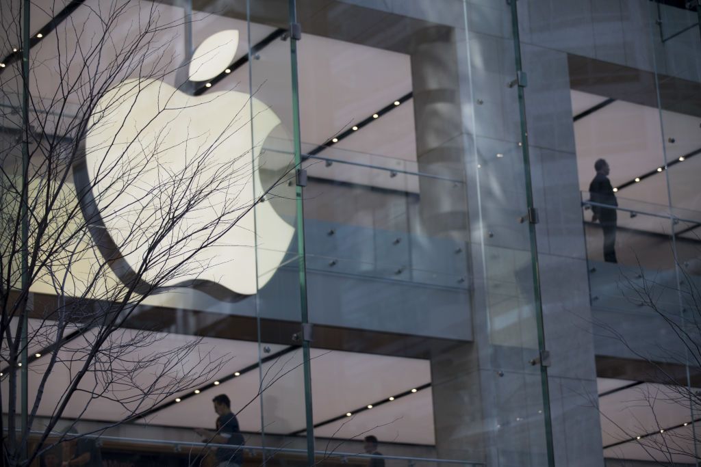 illuminated Apple logo outside of building with large windows