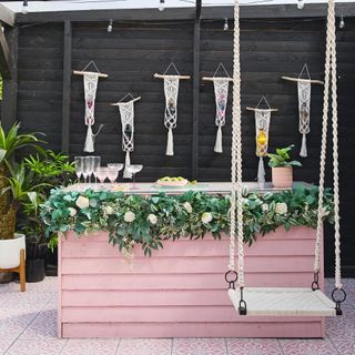 garden with pink DIY bar and swing